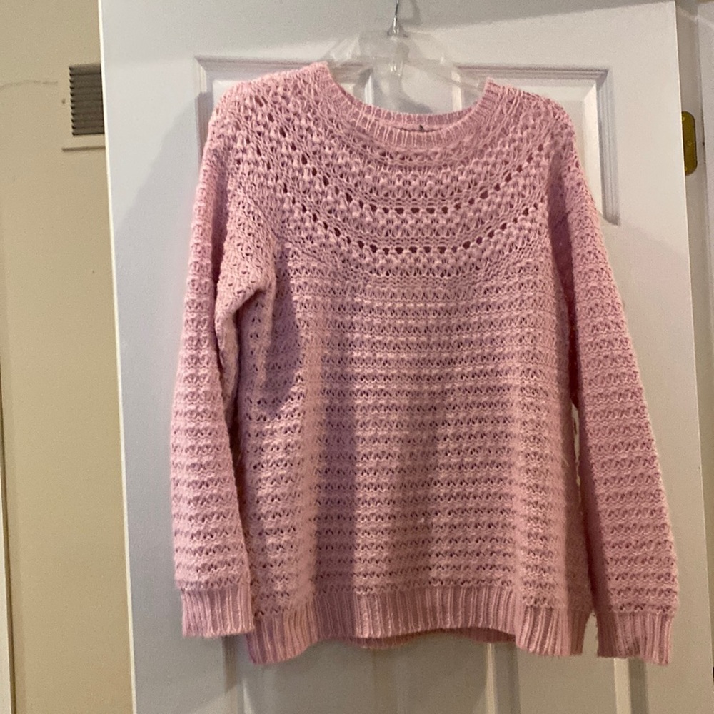 Soft pink crocheted look sweater.